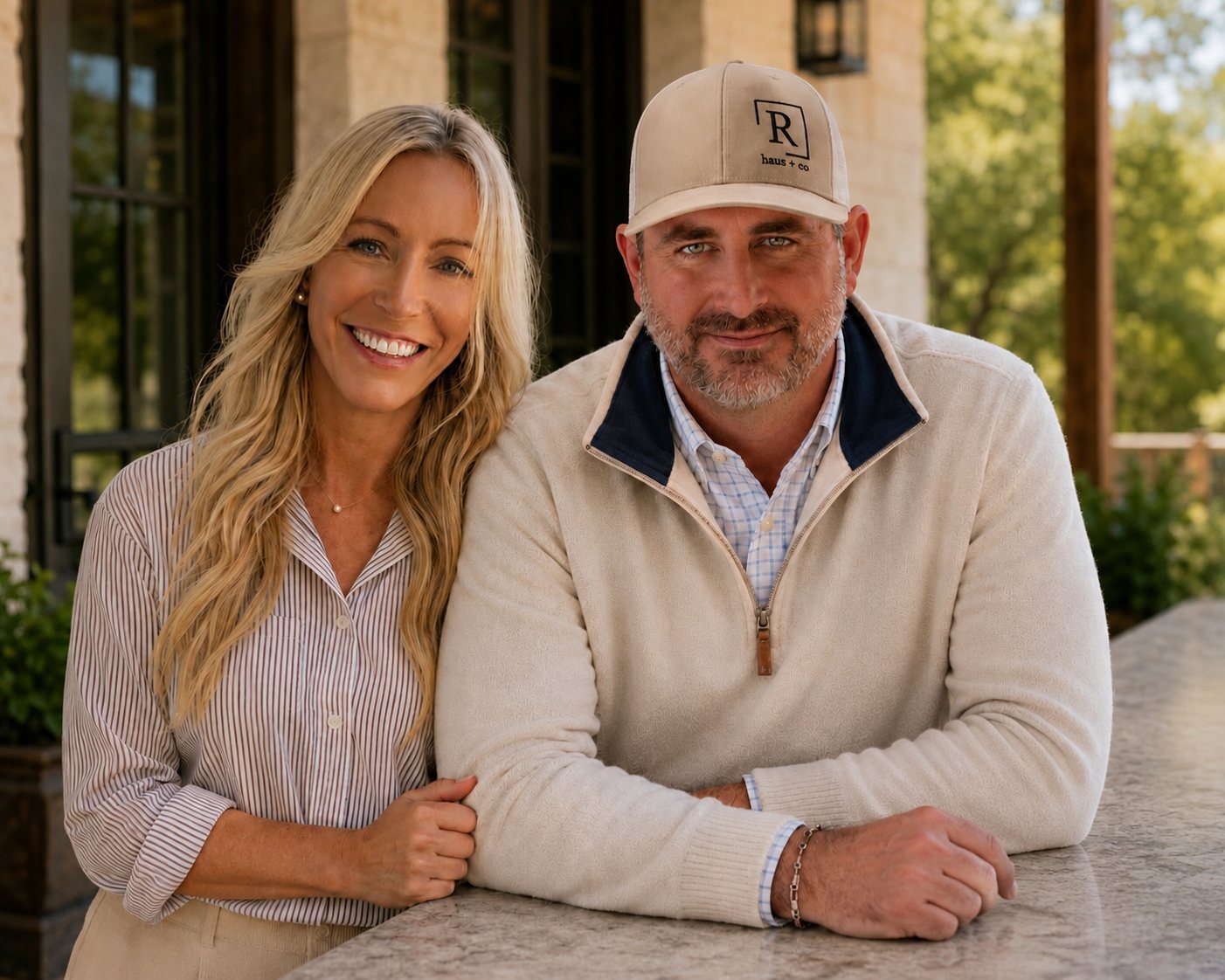 Michael and Joanna Ruesch standing together outside a stone building, Michael in a cap and Joanna in a striped shirt